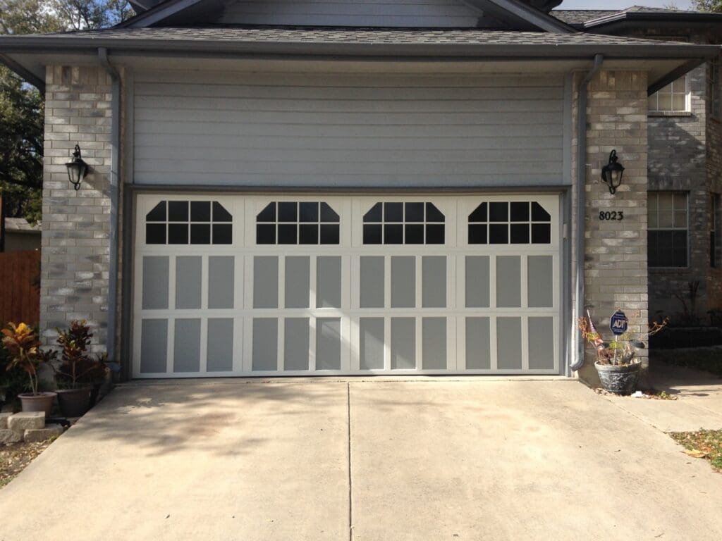 Garage door replacement contractor installing an attractive residential door for homeowners searching best garage door replacement near me, garage door replace near me, and cost to replace garage door.