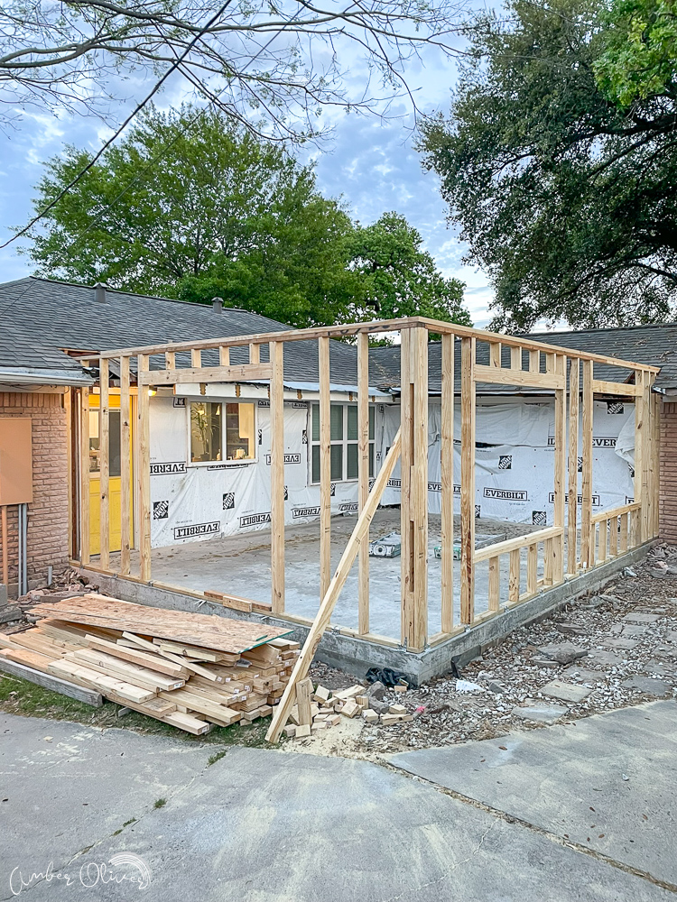 Residential home addition under construction with new wood wall framing and concrete foundation, showing the type of expansion homeowners may consider when researching Home addition builders, home addition companies, house extension builders near me, and home addition contractors.