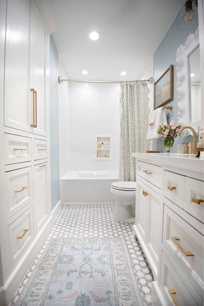 Bright remodeled bathroom featuring custom cabinetry, bathtub, vanity, and modern finishes by a Bathroom remodel company specializing in bath remodel, local bath renovation contractors, bathroom design and build firms, and bathroom contractor near me services.