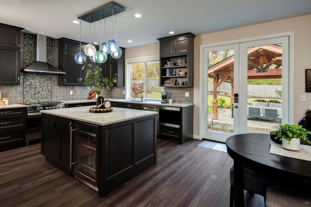 Modern renovated kitchen completed by a General contracting company, featuring the type of coordinated home improvements offered by a bath remodeling company, kitchen remodeling company, complete rehab companies, and window replacement contractor.