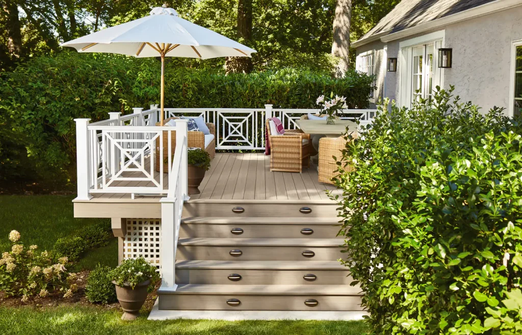 General contracting company creating a beautiful outdoor deck and entertaining space for homeowners comparing a bath remodeling company, kitchen remodeling company, complete rehab companies, and window replacement contractor for additional home improvements.