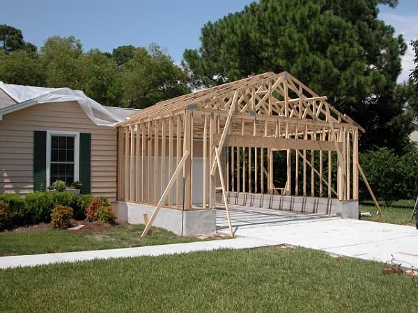 Residential garage builders constructing a framed garage addition as garage builders complete the structure for homeowners searching for garage contractors near me, detached garage builders, and custom garage builders near me.