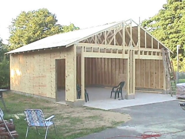 Residential garage builders constructing a two-car garage as garage builders complete the wood framing and roof for homeowners searching for garage contractors near me, detached garage builders, and custom garage builders near me.