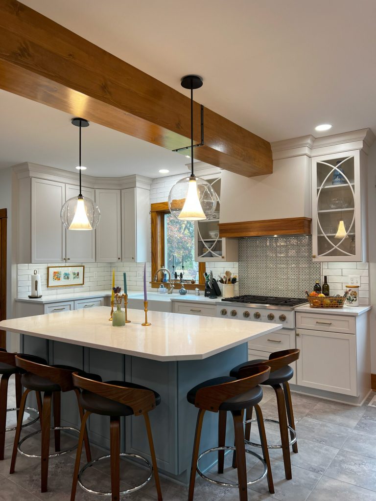 Modern remodeled kitchen by a Kitchen remodeling contractor, featuring custom cabinetry, a large center island, pendant lighting, and updated finishes from a kitchen remodeling company, kitchen remodelers, companies that remodel kitchens, and kitchen renovation contractors.
