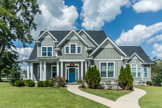 Modern two-story home featuring Hamilton windows, representing window replacement Hamilton, window installer Hamilton, vinyl window replacement Hamilton, and professional window replacement services for homeowners.