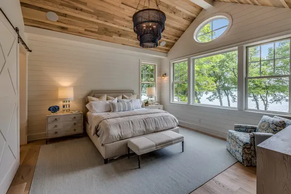 Bright bedroom with multiple replacement windows providing natural light, featuring Window installers near me, a local window installation company, local window replacement company, and home window replacement company.
