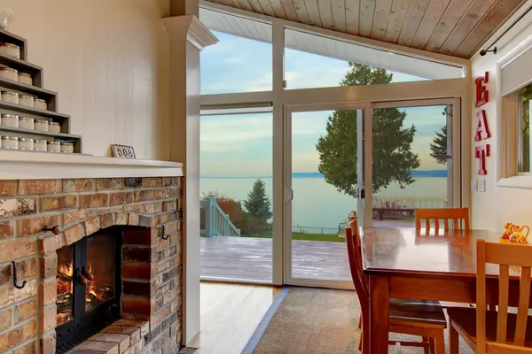 Bright home interior with large scenic windows installed by Local window installers, a local window installation company, local window replacement company, and home window replacement company.