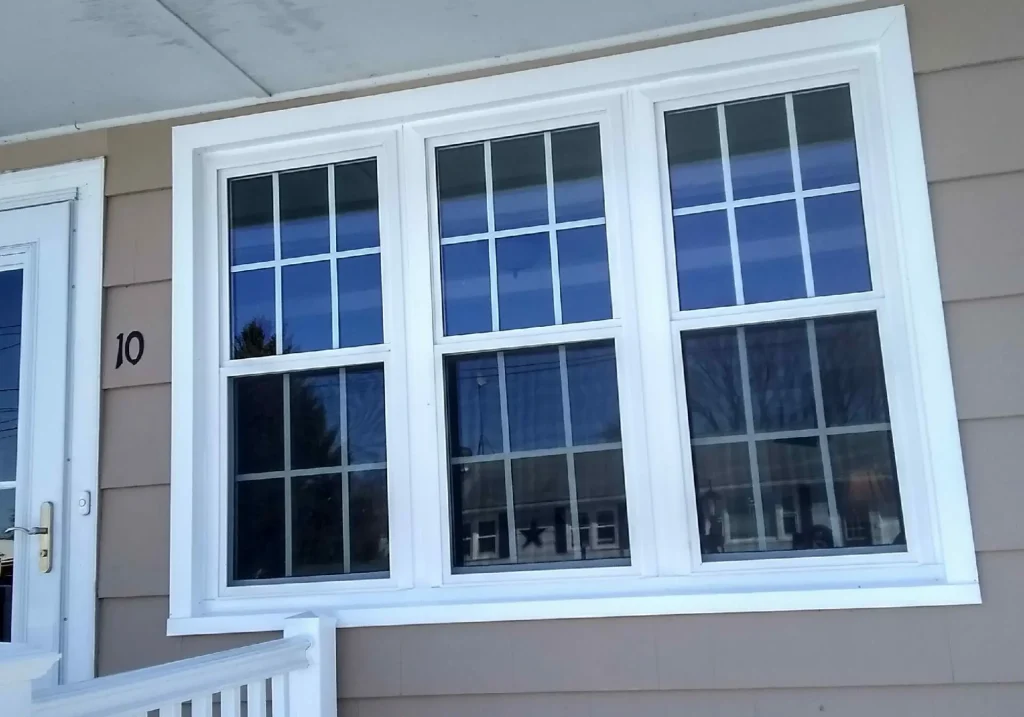 Exterior home with three professionally installed windows featuring Window replacement near me, replacement windows near me, a local window company, local window contractor, and replacement window contractor services.